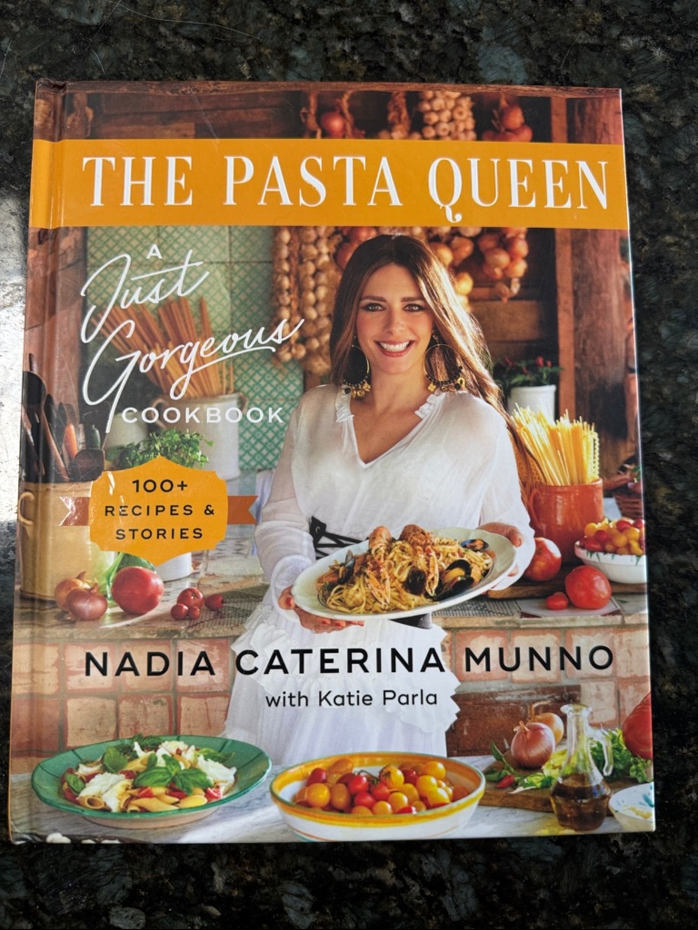 The Pasta Queen Cookbook by Nadia Caterina Munno - Orange & White Cover